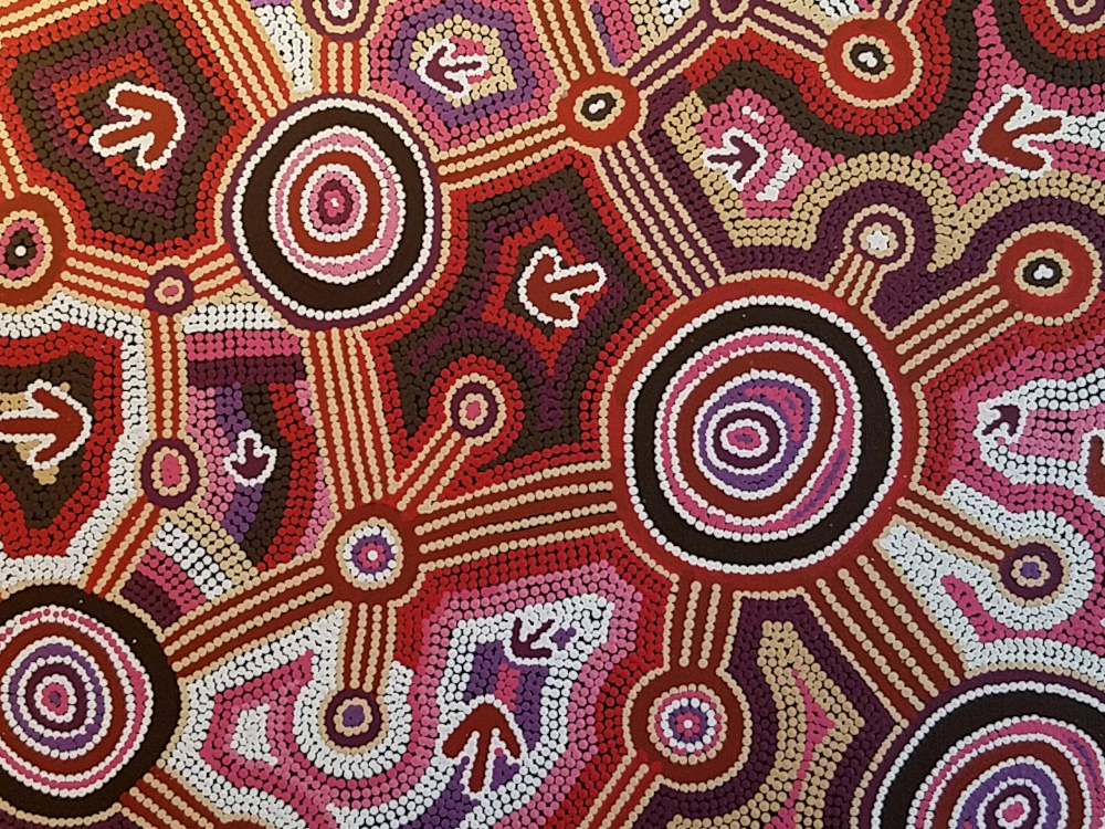 an oil painting composed of red, pink, purple, black, and white dots, forming concentric circles, lines, and arrows